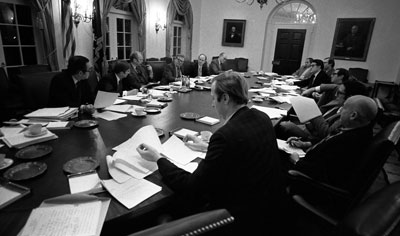 President Ford and his advisers listen to a comment by speechwriter Robert Hartmann at a nighttime meeting devoted to President Ford’s upcoming State of the Union speech. 