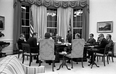 President Ford conducts a nighttime meeting with his advisers to discuss a note received from Soviet General Secretary Leonid Brezhnev about Strategic Arms Limitation Talks (SALT).