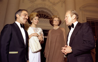 President and Mrs. Ford say goodnight to King Hussein and Princess Alia of Jordan as they depart the White House after a state dinner in their honor.  
