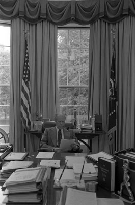 President Ford studies a speech during a meeting with his editorial staff.  Oval office .  May 1, 1976.   