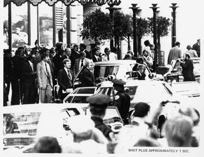 Reaction of Secret Service agents, police, and bystanders approximately one second after Sara Jane Moore attempted to assassinate President Gerald R. Ford.