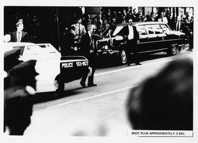 Reaction of Secret Service agents, police, and bystanders approximately three seconds after Sara Jane Moore attempted to assassinate President Gerald R. Ford in San Francisco, California.  