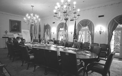 President Ford conducts a National Security Council meeting to discuss the evacuation of Americans from Beirut following the assassinations of U.S. Ambassador to Lebanon Francis E. Meloy, Jr. and Economic Counselor Robert O. Waring on June 16.  June 17, 1976.  Cabinet Room.  [clockwise:  President Ford, Deputy Defense Secretary William Clements, Counsellor John Marsh, Joint Chiefs of Staff Chairman General George S. Brown, CIA Director George H.W. Bush, National Security Adviser Lt. Gen. Brent Scowcroft, Chief of Staff Dick Cheney, Special Emissary to Lebanon L. Dean Brown, and Secretary of State Henry A. Kissinger.   