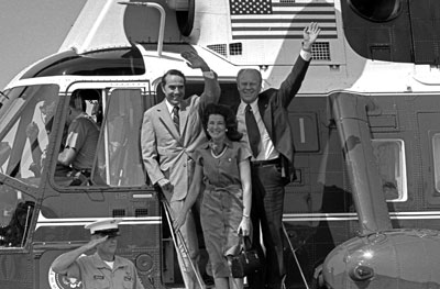 President Ford, vice presidential running mate Senator Robert Dole and Mrs. Elizabeth Dole debark Marine I to attend a campaign rally in the Senator’s hometown.  