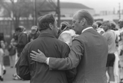President Ford and University of Michigan football coach Bo Schembechler walk toward the practice field.  