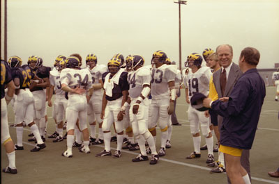 President Ford and coach Bo Schembechler watch the University of Michigan football team practice. 
