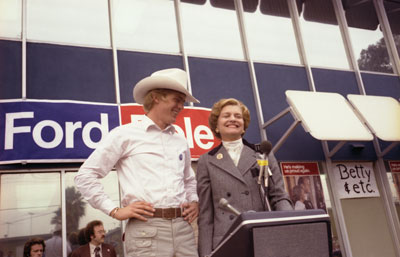 First Lady Betty Ford introduces her son Steve to a crowd gathered outside a President Ford Committee phone bank in Downey, California.  