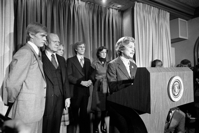 Mrs. Ford reads President Ford's concession speech to the press. (l-r) Steve, President Ford, Susan, Mike, Gayle