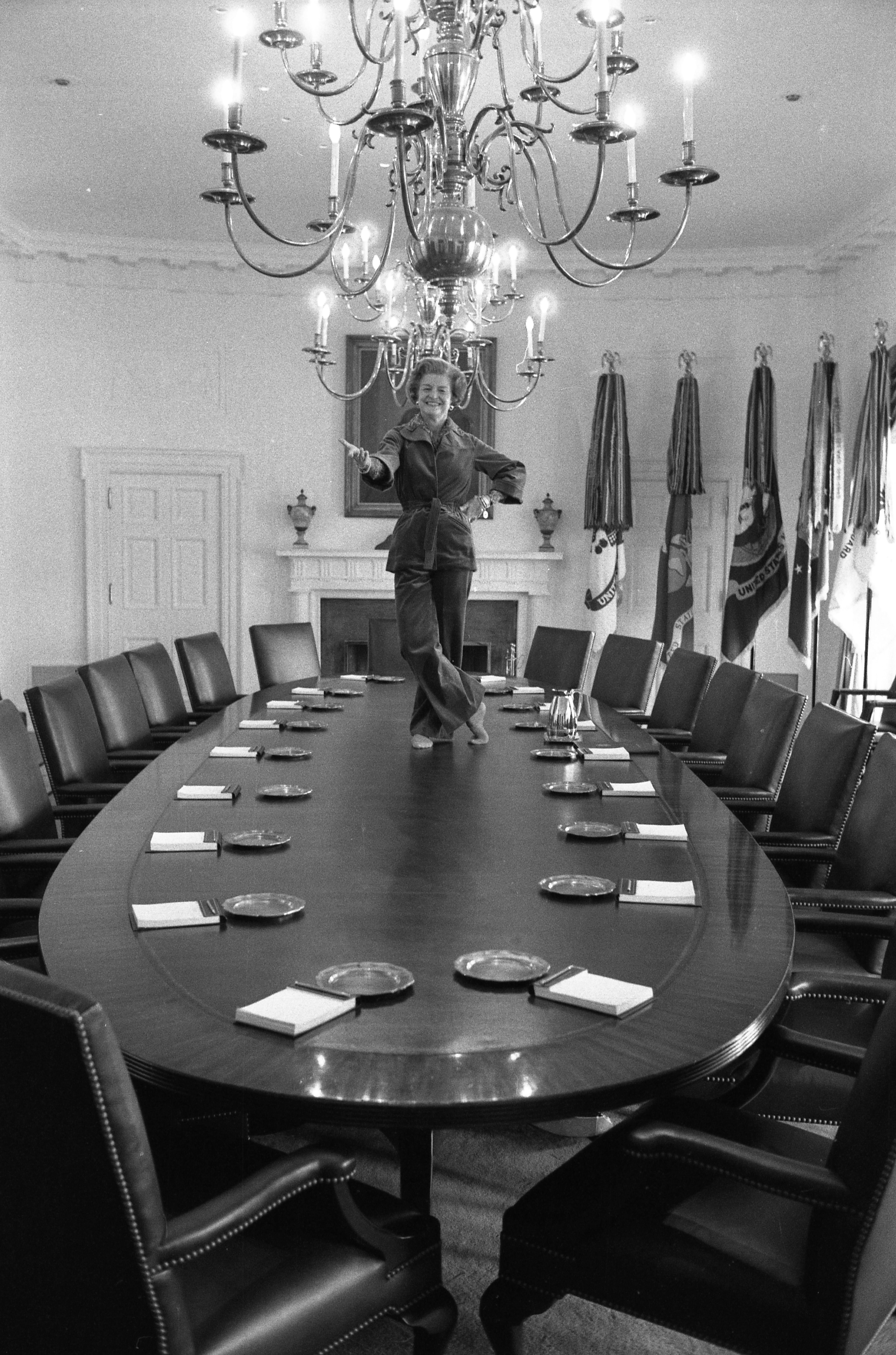 First Lady Betty Ford dances on the Cabinet Room table on the day before departing the White House upon the inauguration of President Jimmy Carter.