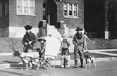 Gerald R. Ford, Jr., Carl Engel, Tom Ford, and an unidentified boy pose with their pioneer wagon after winning first prize in the Boys Day Parade. 