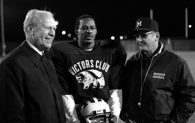President Ford visits with University of Michigan Coach Bo Schembechler and All-American receiver Anthony Carter during a visit to Ann Arbor.