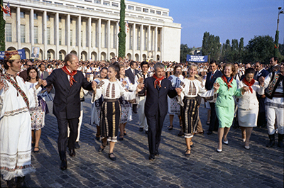 President Ford, First Lady Betty Ford, Romanian President Nicolae Ceausescu, and Mrs. Ceausescu dancing with folk dancers in Bucharest, Romania.  