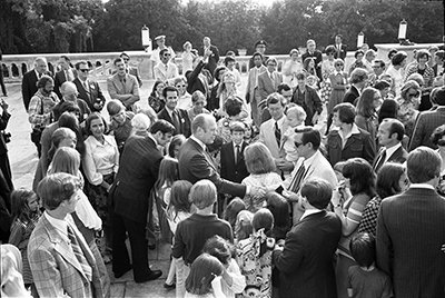 President Ford greeting American embassy staff members and their families on the patio outside the Old Palace in Belgrade, Yugoslavia.