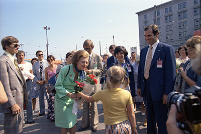 First Lady Betty Ford receiving flowers from a young girl during her tour of Helsinki, Finland.