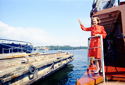 First Lady Betty Ford waving from a ferry as it docks at Katajanoka Pier during her tour of Helsinki, Finland.