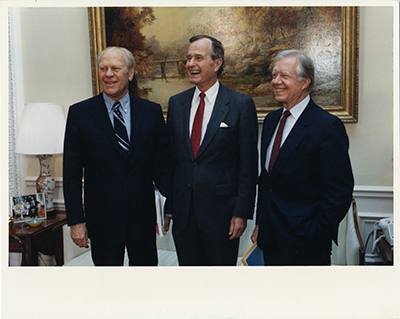 Former Presidents Gerald R. Ford and Jimmy Carter with Vice President and President-elect George H.W. Bush at the White House to present him with the American Agenda.