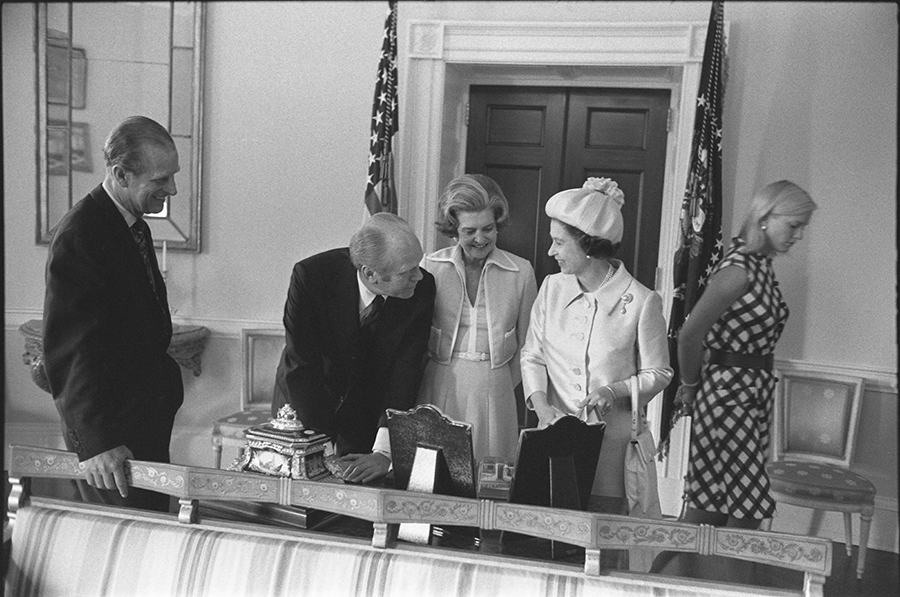 Queen Elizabeth II and Prince Philip present state gifts to President Ford, Mrs. Ford, and Susan Ford in the Yellow Oval Room.