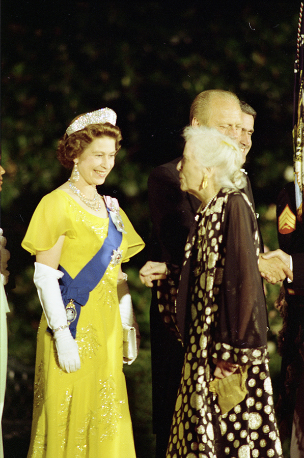 Queen Elizabeth II greeting Alice Roosevelt Longworth, daughter of President Theodore Roosevelt, in the receiving line on the South Driveway of the White House prior to a state dinner honoring Her Majesty.