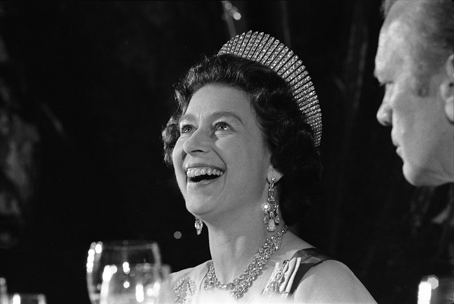 Queen Elizabeth II laughs during a state dinner held in her honor.
