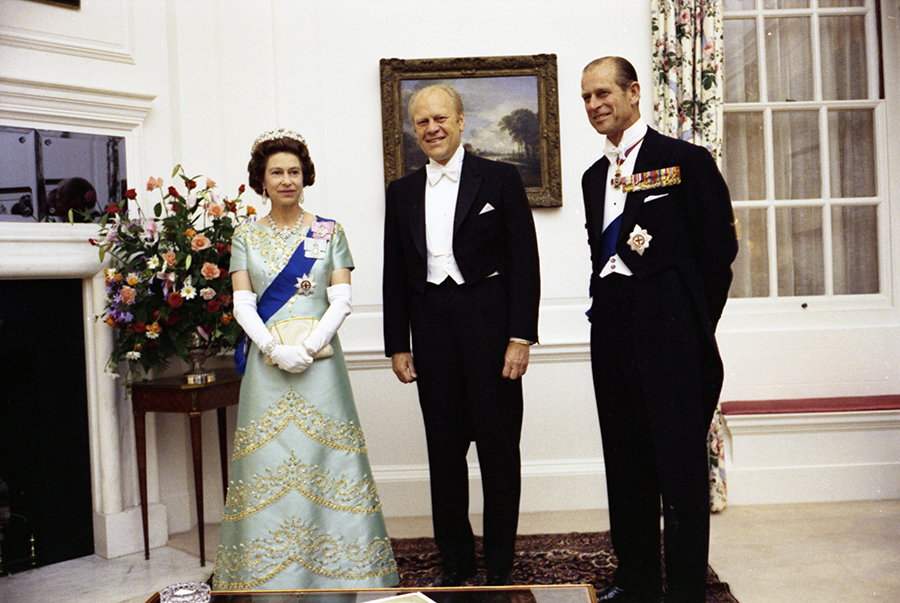 Queen Elizabeth II, President Ford, and Prince Philip at the British Embassy in Washington, DC for a reciprocal state dinner hosted by the Queen.