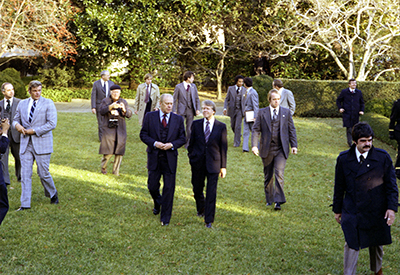 President Ford and President-elect Jimmy Carter walk through the Rose Garden following the arrival of the Carters for a tour of the White House.