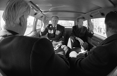 President Ford, President-elect Jimmy Carter, Speaker of the House Thomas P. Tip O'Neill, and Senator Howard Cannon riding in a limousine in the motorcade to the Inauguration of Jimmy Carter as the 39th President of the United States.