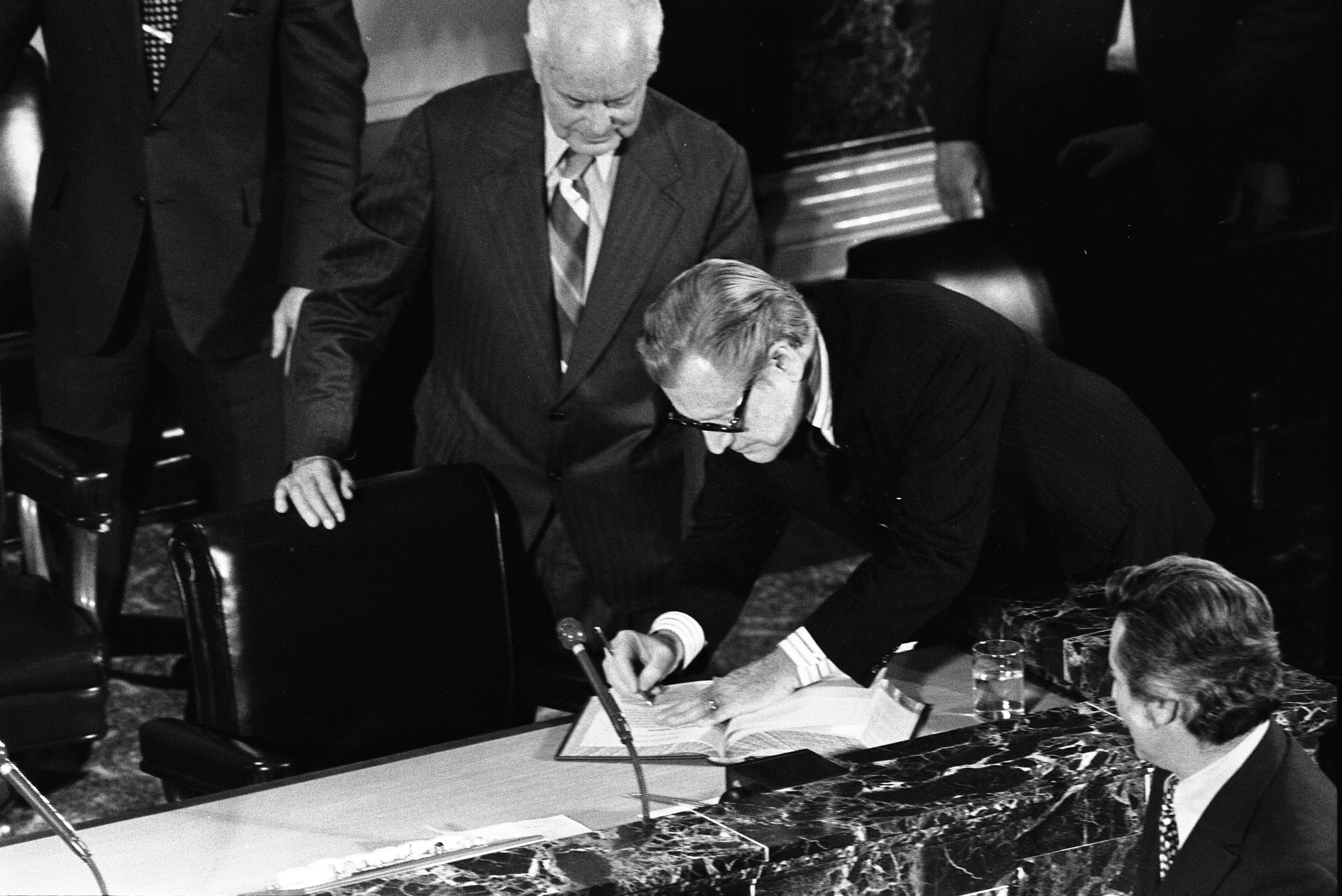 Nelson Rockefeller signing Senate book before addressing the joint assembly.