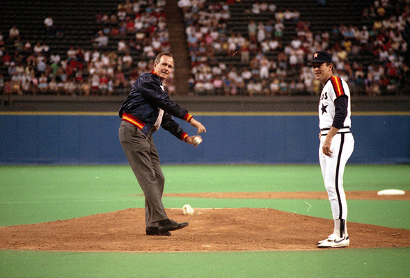 Vice President Bush throws out the first pitch at the Houston Astros game in the Astrodome as pitcher Nolan Ryan looks on, August 28, 1988.