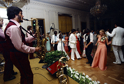 Susan Ford, her classmates, and their dates dancing while the band Sandcastle plays at the Holton-Arms School Senior Prom, 5/31/1975