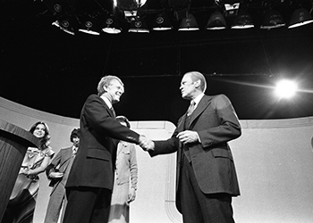 President Ford and Jimmy Carter shake hands to begin the debate