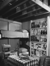 How to build a fallout shelter - Attractive interior of basement family fallout shelter includes a 14-day shelter food supply which may be stored indefinitely, a battery-operated radio, auxiliary light sources, a two-week supply of water, and first aid, sanitary and other miscellaneous supplies and equipment, ca. 1957 