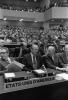 Gerald R. Ford, Kissinger, Hartman are seated at a desk Opening of the Conference on Security and Cooperation in Europe