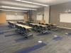 A large conference room with tables and chairs is shown