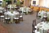 Round tables with tablecloths are set up across the room