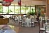 Round tables with tablecloths are set up across the room