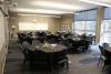 Round tables with black linens are shown