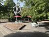The back patio at the Library, paved with bricks, features art work and furniture.