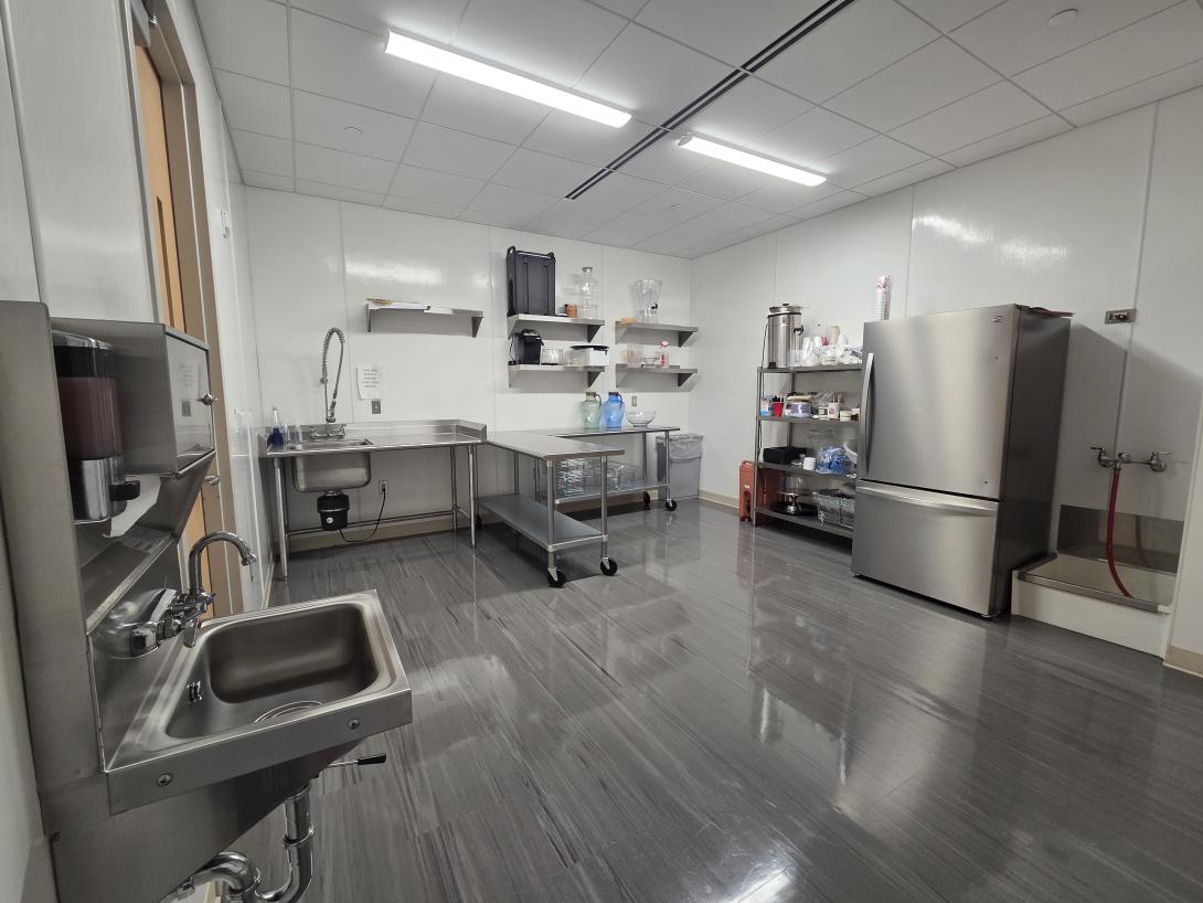 Catering kitchen with large sink and metal tables