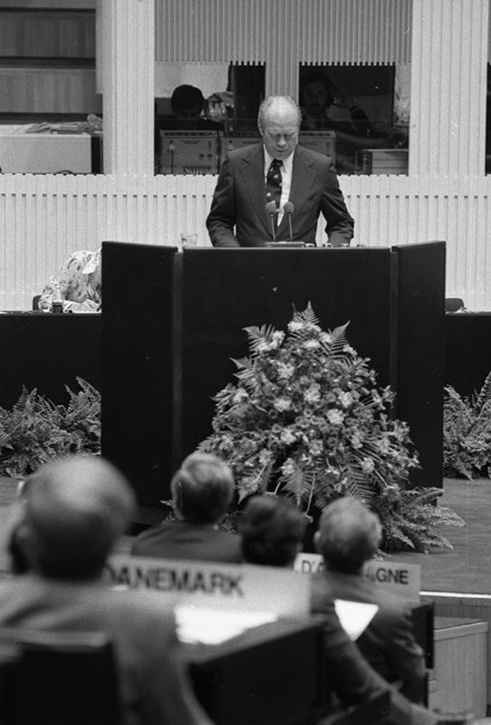 Gerald R. Ford speaks at the podium at the Conference on Security and Cooperation in Europe (CSCE).