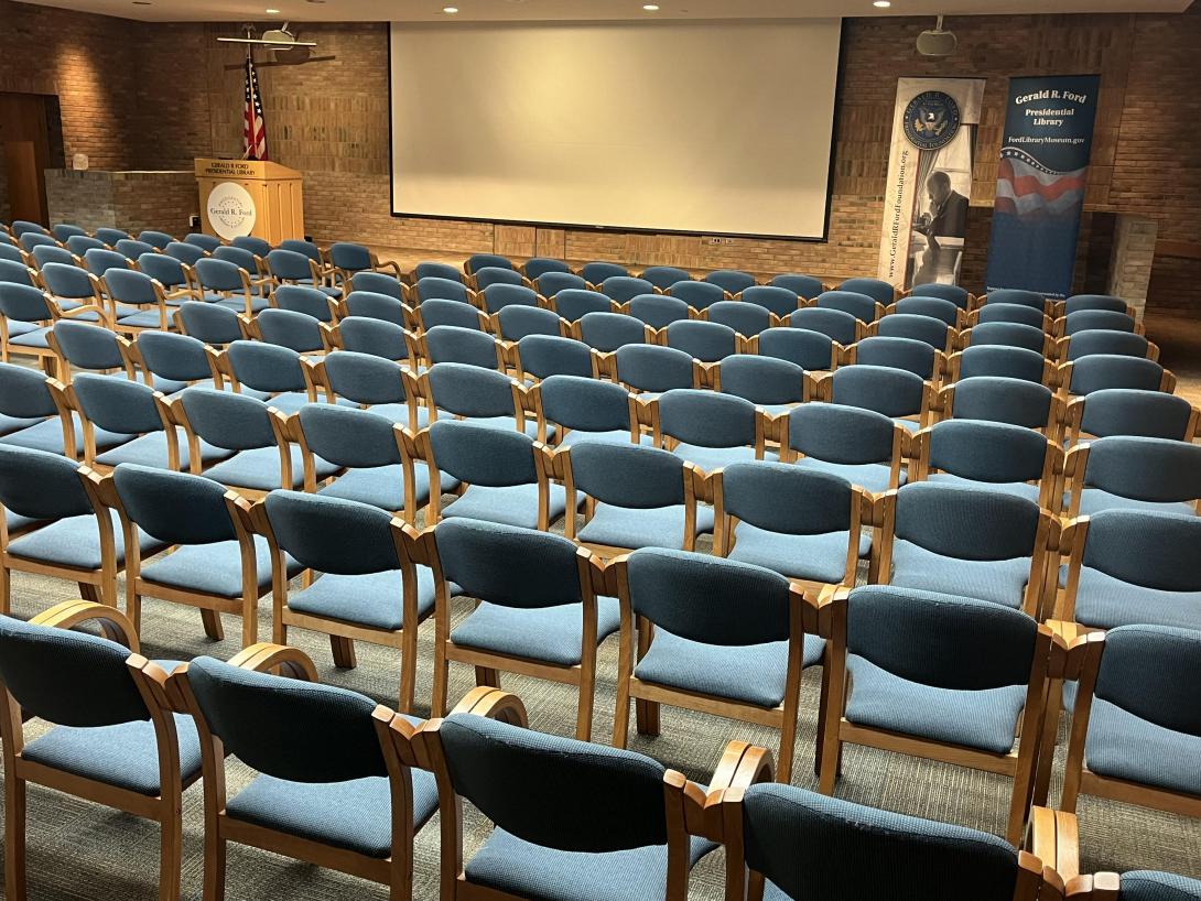 Chairs are aligned in rows facing a stage