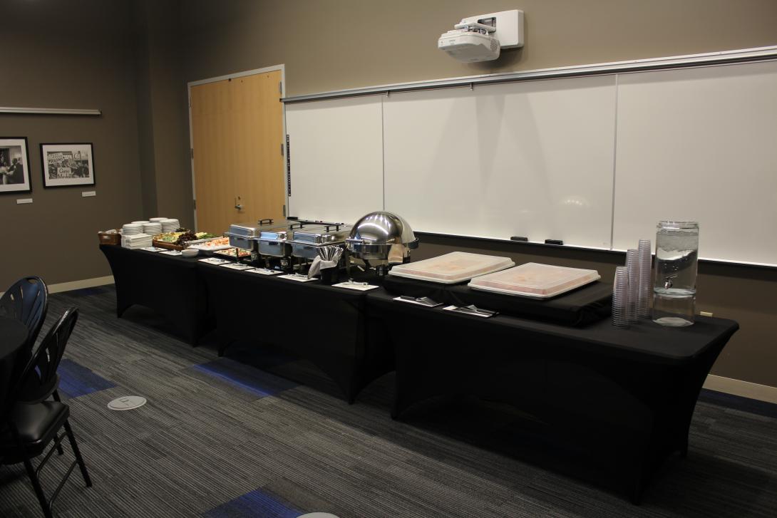 A catering table with black linen is shown